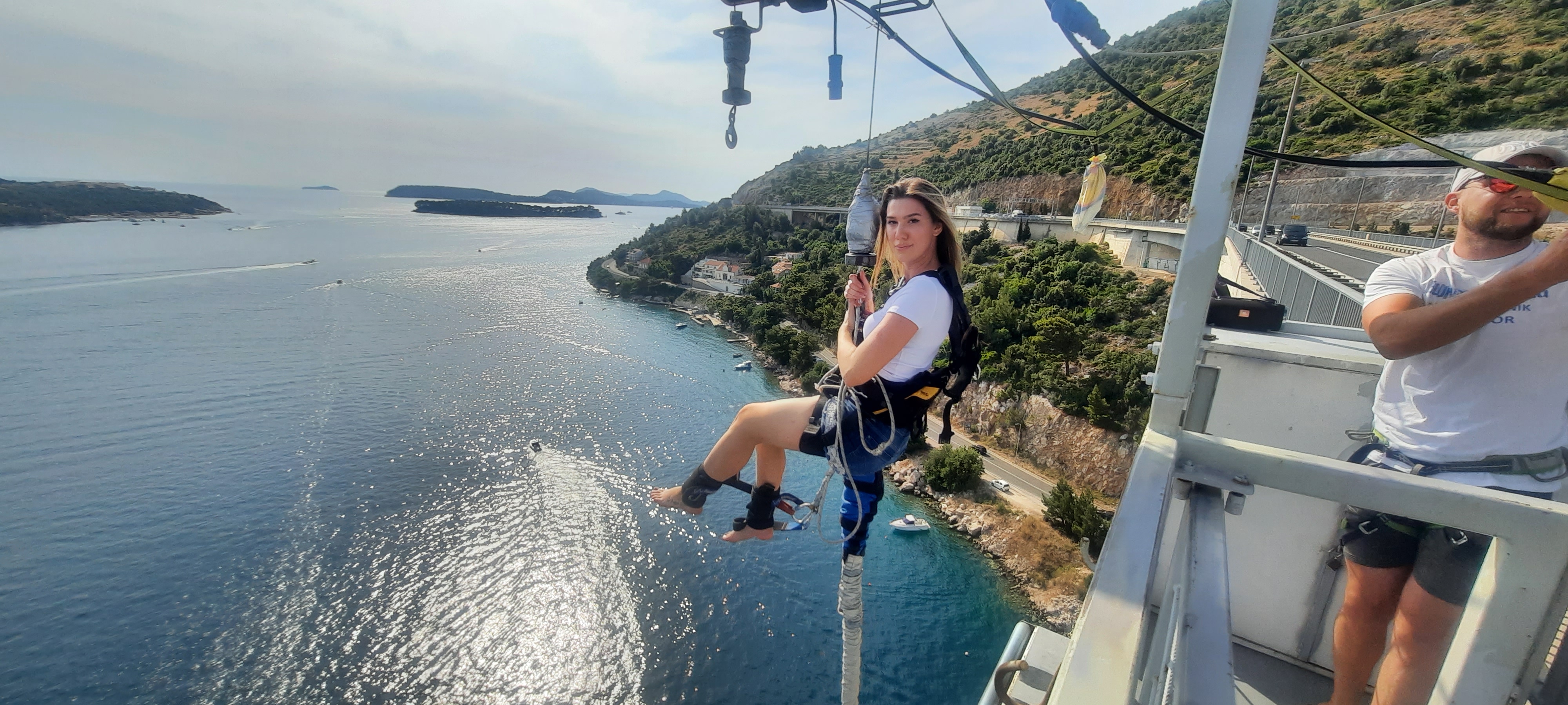 Female participant secured in a safety harness before a Dubrovnik Bungee Jump overlooking the Adriatic coast