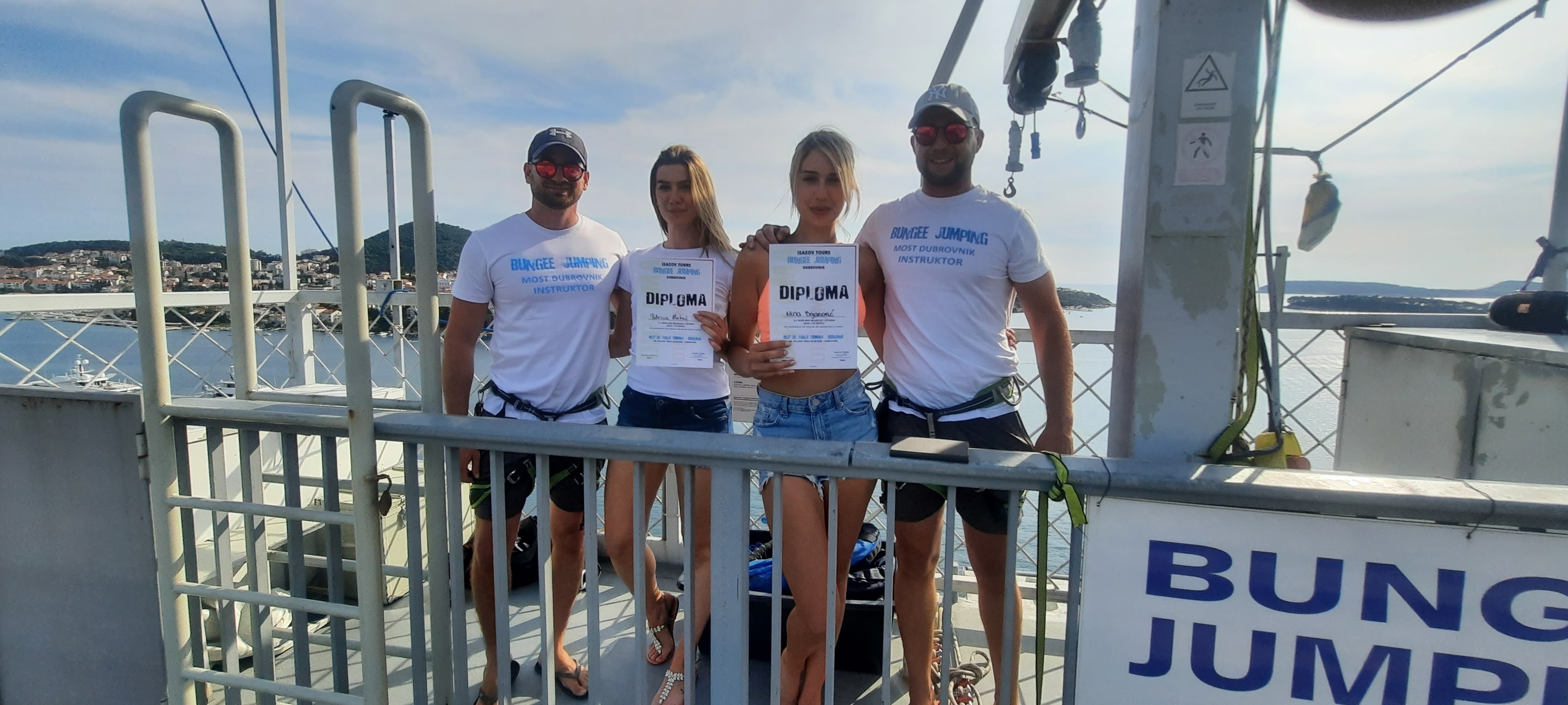 Bungee jump instructors and participants posing with diplomas after a successful Dubrovnik Bungee Jump experience