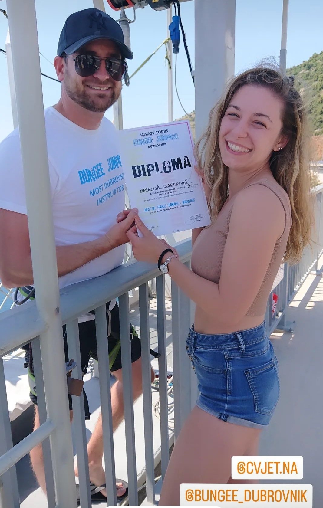 Smiling participant receiving a diploma after completing a Dubrovnik Bungee Jump experience