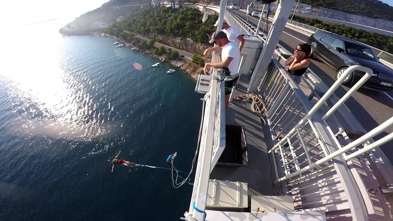 Participant standing on the Dubrovnik Bungee Jump platform preparing for an adrenaline-filled jump above the Adriatic Sea