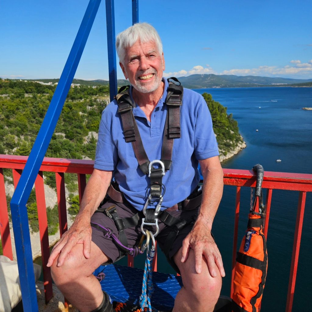 Senior participant smiling before bungee jumping at Maslenica Bridge